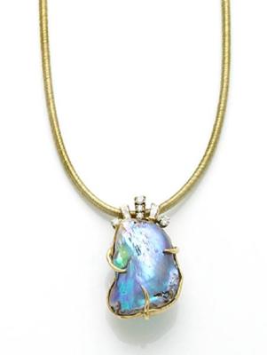 At Auction: 18K gold mother of pearl and diamond mounted pendant
